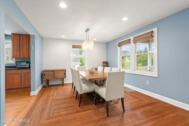 a dining room with furniture window and wooden floor