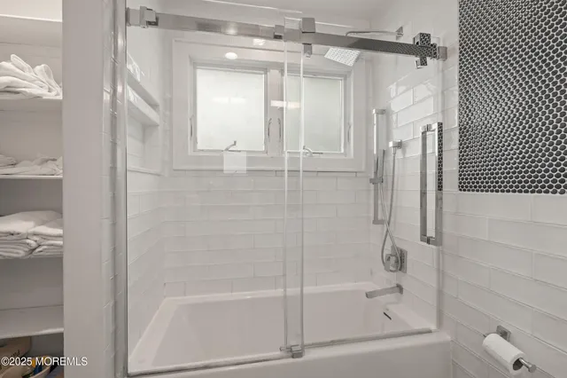 a bathroom with a glass shower door