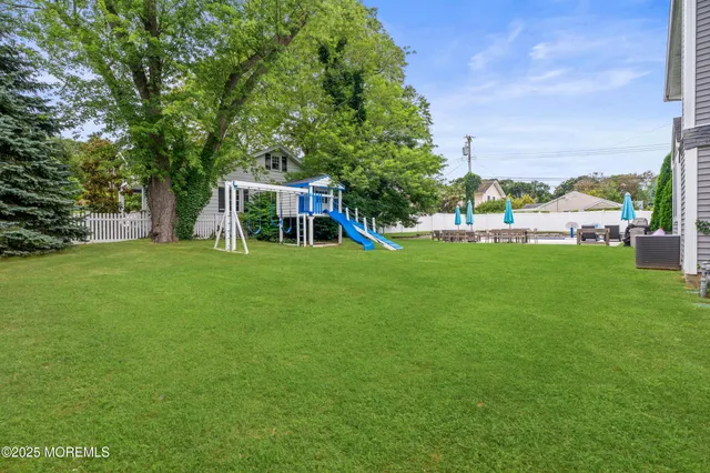 a view of a house with a backyard porch and sitting area