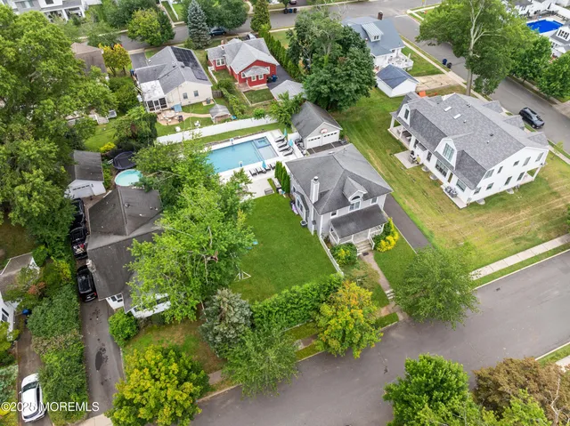 an aerial view of residential house with outdoor space and swimming pool