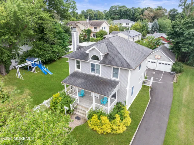 an aerial view of a house with a big yard