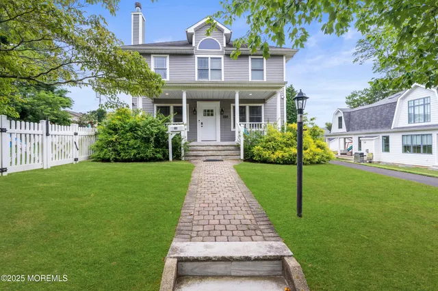 a front view of house with yard and green space