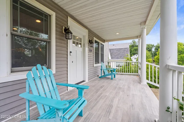 a porch with a table and chairs