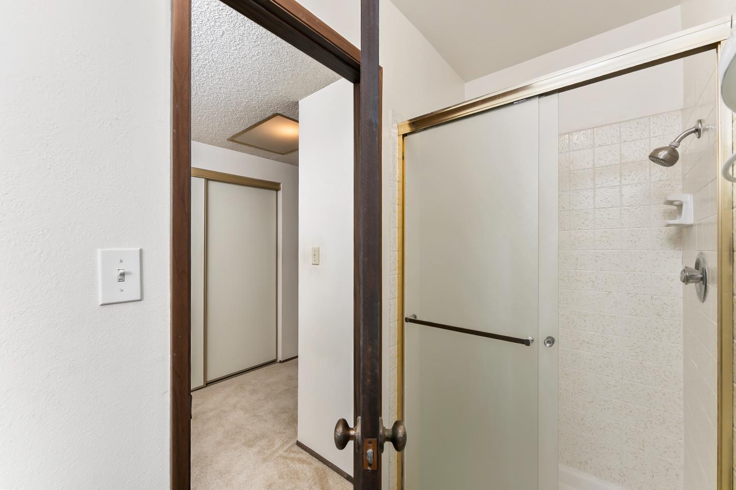 3126 Oxford Road Cameron Park, CA 95682 - Photo 22 of 45 a view of a bathroom with a shower and a sink