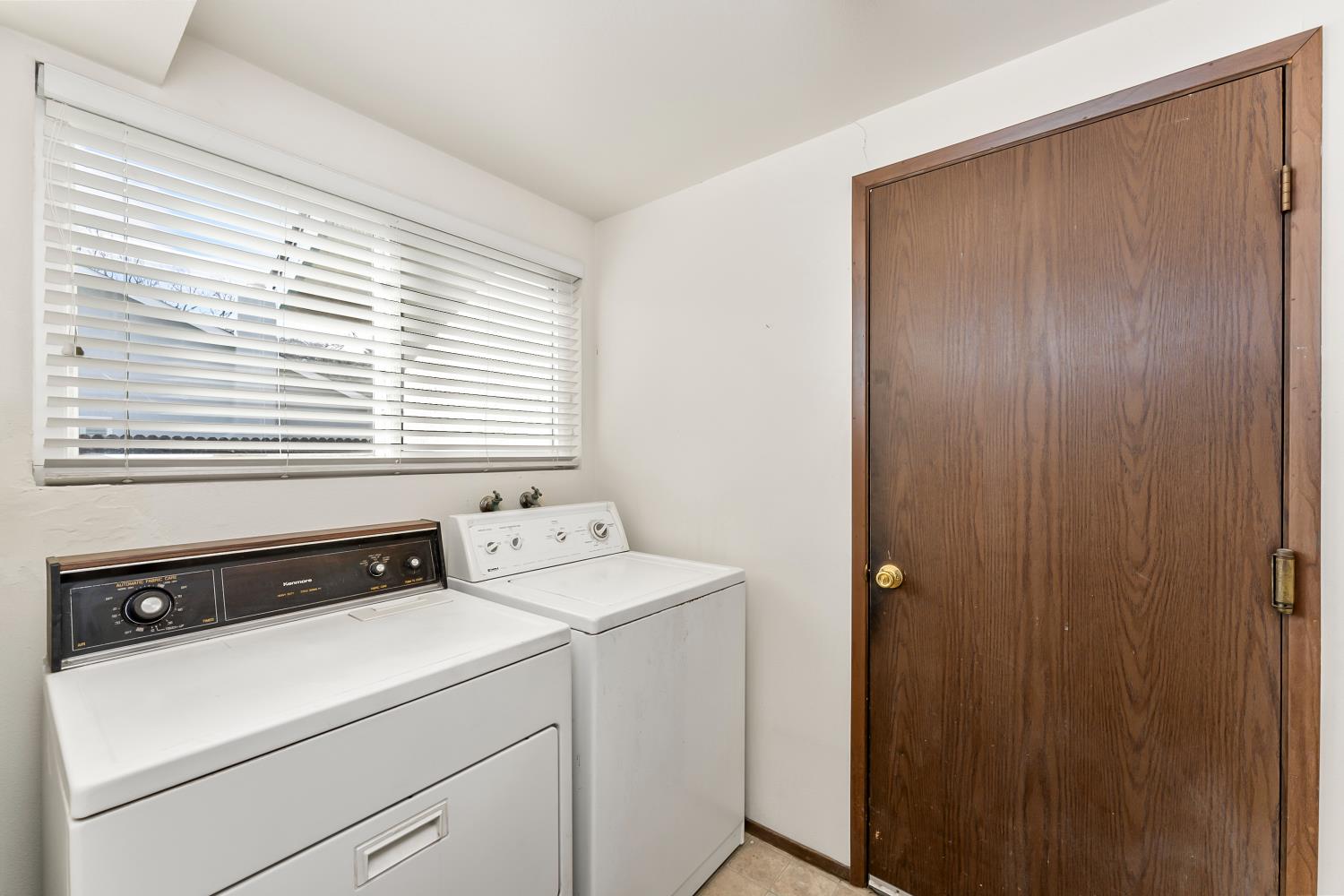 3126 Oxford Road Cameron Park, CA 95682 - Photo 30 of 45 a view of washer and dryer with bathroom in the background