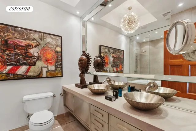 a bathroom with a sink mirror and toilet