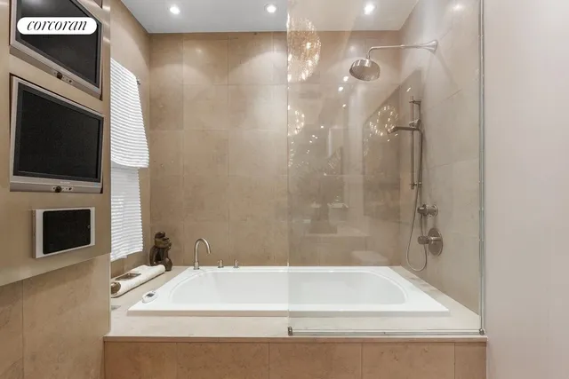 a bathroom with a bathtub and a shower