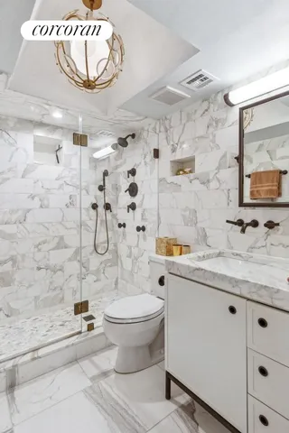 a bathroom with a granite countertop sink mirror toilet and bathtub