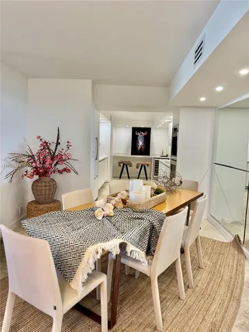 a bedroom with a bed and a dresser next to a window