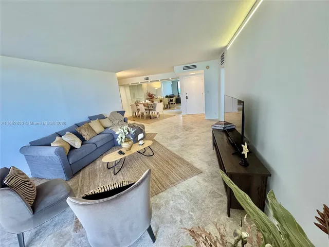 a view of a dining room with furniture and a chandelier