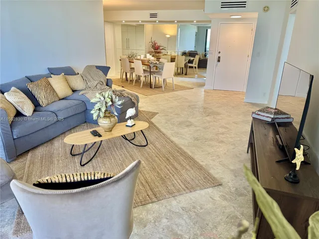 a view of a dining room with furniture and a chandelier