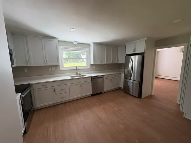 a kitchen with stainless steel appliances granite countertop a refrigerator sink and cabinets