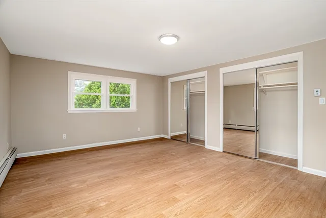 an empty room with windows and closet