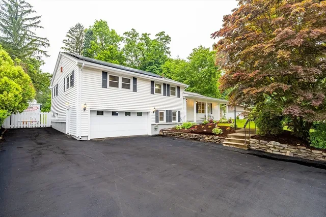a view of a house with a yard and sitting area