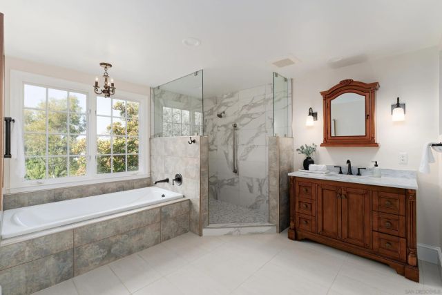 a spacious bathroom with sink shower bathtub and window