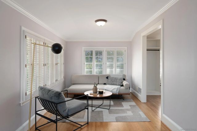a living room with furniture and a floor to ceiling window