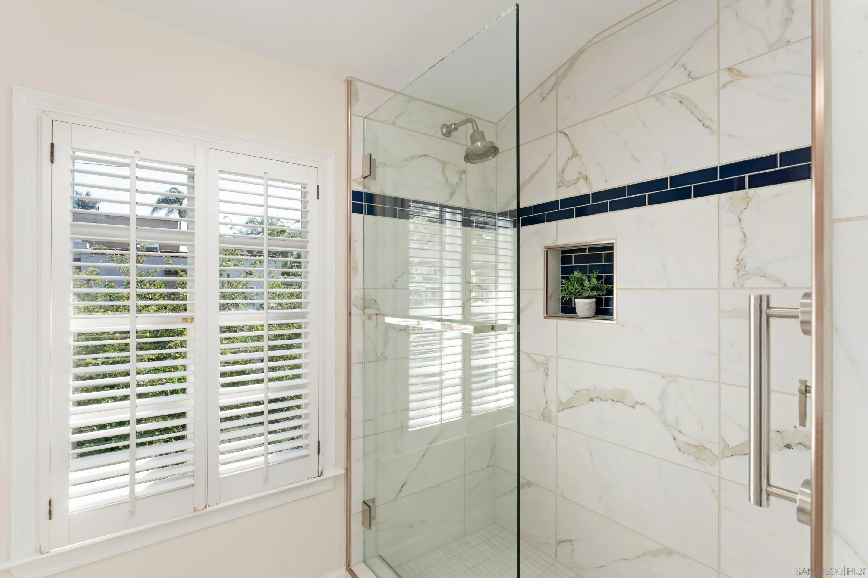1506 Plumosa Way San Diego, CA 92103 - Photo 17 of 30 a bathroom with a shower and a window