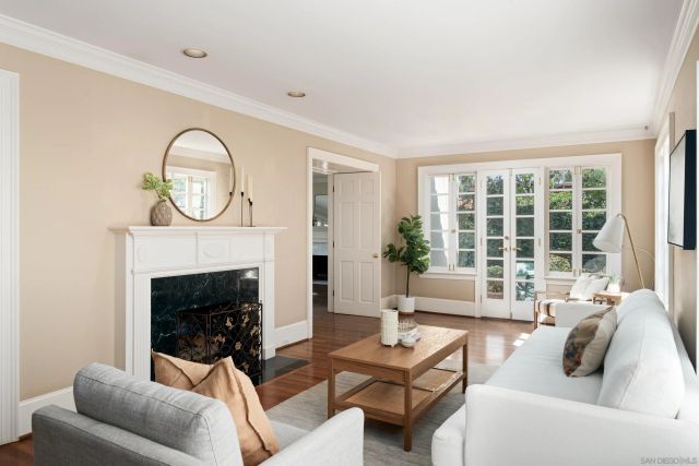 a living room with furniture a window and a fireplace