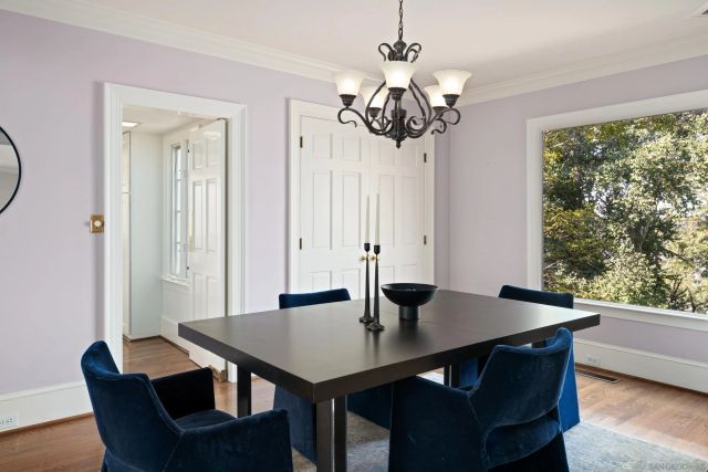a view of a dining room with a table and chairs