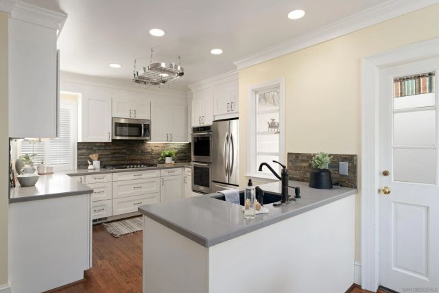 a kitchen with granite countertop a sink appliances and cabinets