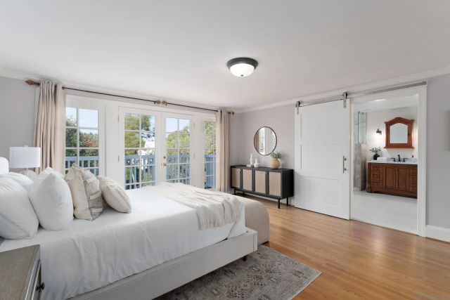 a bedroom with a large bed and a large window