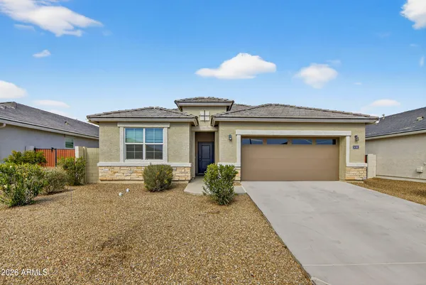 a view of a house with a yard and potted plants