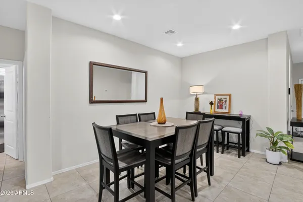 a kitchen with granite countertop kitchen island stainless steel appliances a refrigerator a stove a sink a dining table and chairs