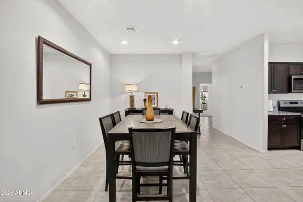 a kitchen with stainless steel appliances granite countertop a sink dishwasher stove and refrigerator with wooden cabinets