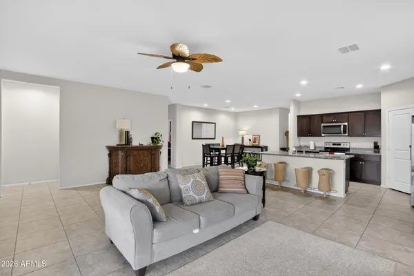 a living room with furniture and a chandelier