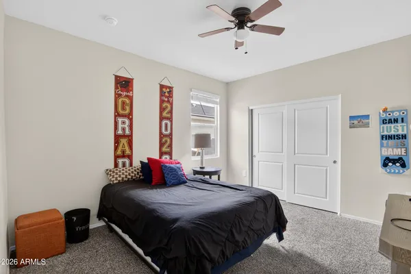 a bedroom with a bed and a chandelier