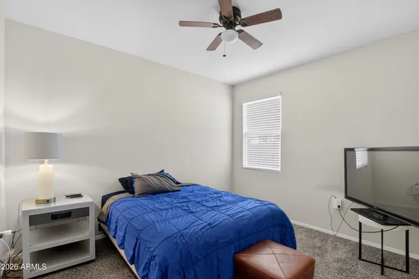 a bedroom with a bed and a window