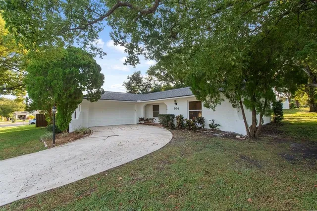a view of a house with a large tree and a big yard