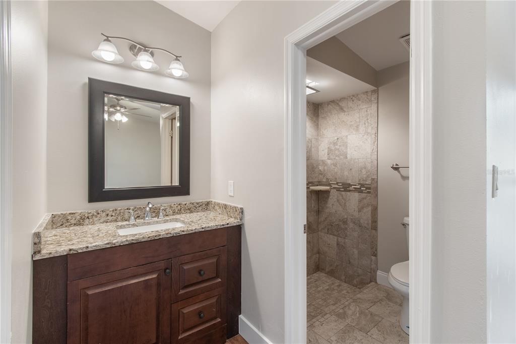 304 Barclay Avenue Altamonte Springs, FL 32701 - Photo 11 of 29 a bathroom with a sink a mirror and a shower
