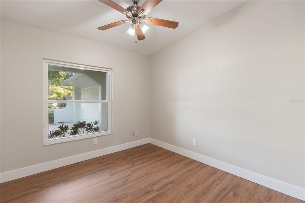304 Barclay Avenue Altamonte Springs, FL 32701 - Photo 12 of 29 an empty room with a window and wooden floor