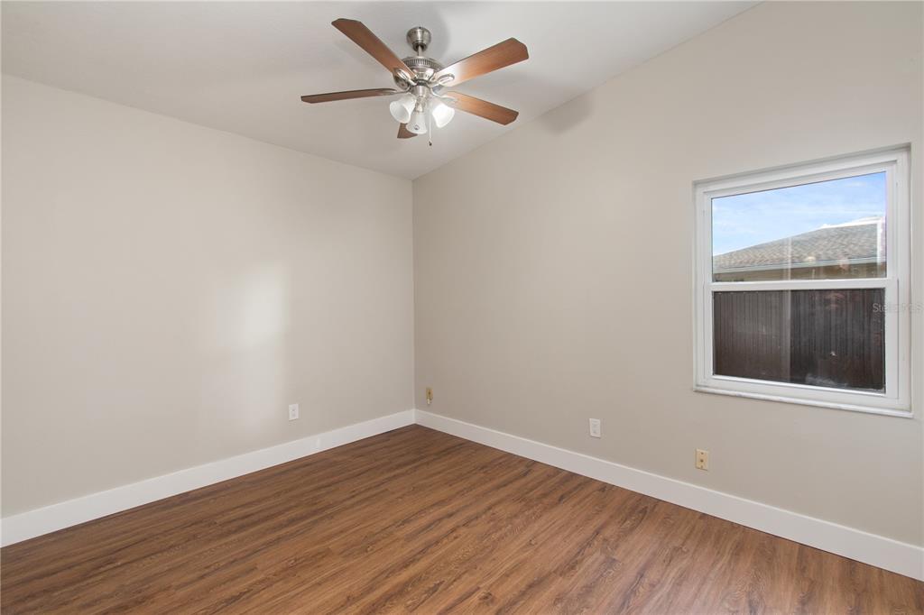 304 Barclay Avenue Altamonte Springs, FL 32701 - Photo 14 of 29 wooden floor in an empty room with a window