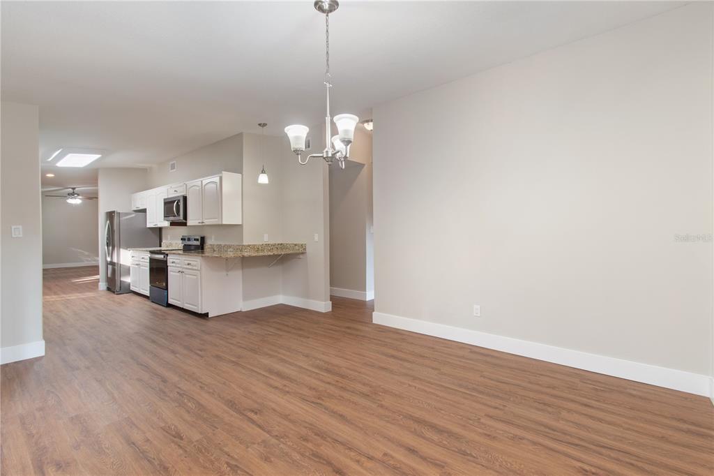 304 Barclay Avenue Altamonte Springs, FL 32701 - Photo 16 of 29 a view of a kitchen with granite countertop stainless steel appliances refrigerator wooden floor and a fireplace