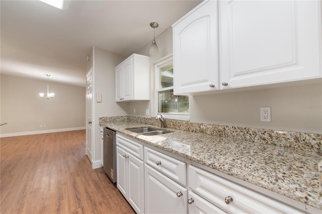 304 Barclay Avenue Altamonte Springs, FL 32701 - Photo 20 of 29 a kitchen with granite countertop white cabinets and a sink