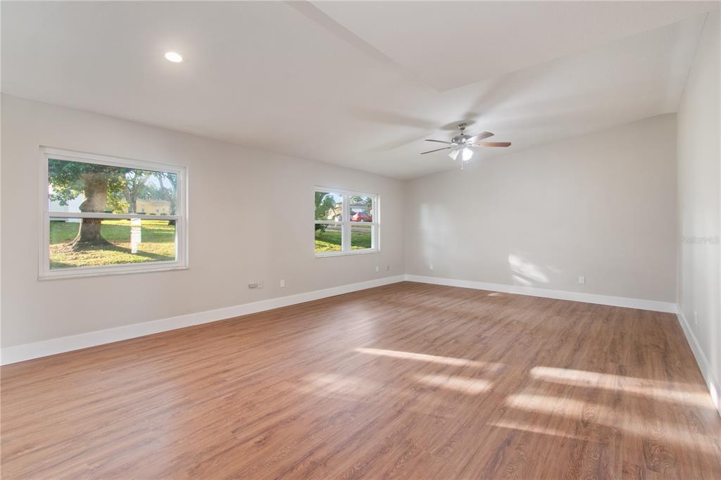 304 Barclay Avenue Altamonte Springs, FL 32701 - Photo 5 of 29 an empty room with wooden floor and windows