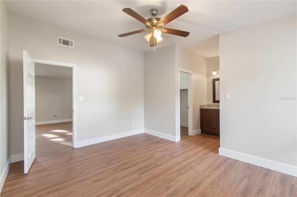 304 Barclay Avenue Altamonte Springs, FL 32701 - Photo 10 of 29 an empty room with wooden floor and a ceiling fan
