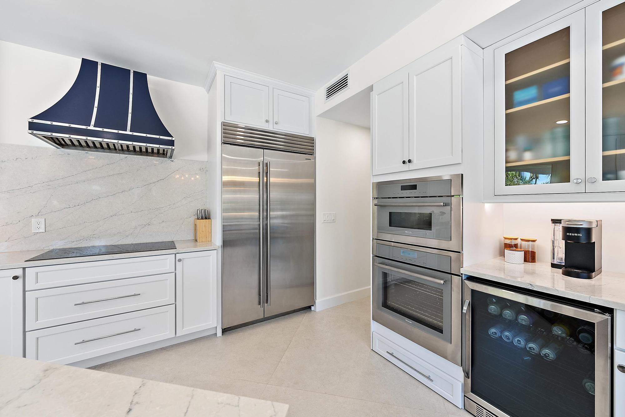 19 Island Road Sewall's Point, FL 34996 - Photo 12 of 50 a kitchen with cabinets and stainless steel appliances