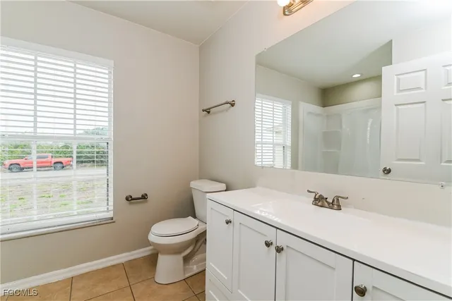 a bathroom with a sink a toilet and a window