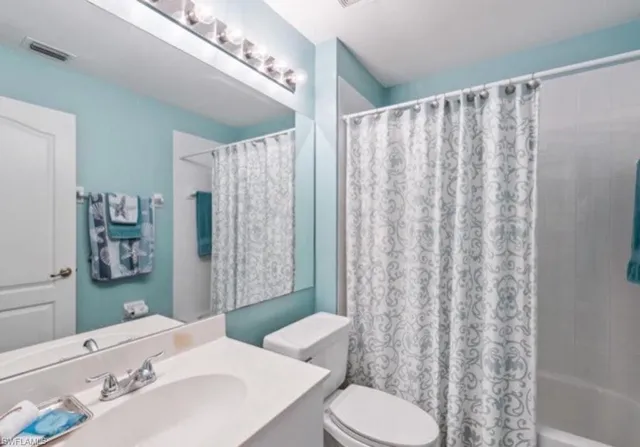 a en suite bathroom with double vanity sinks and a mirror