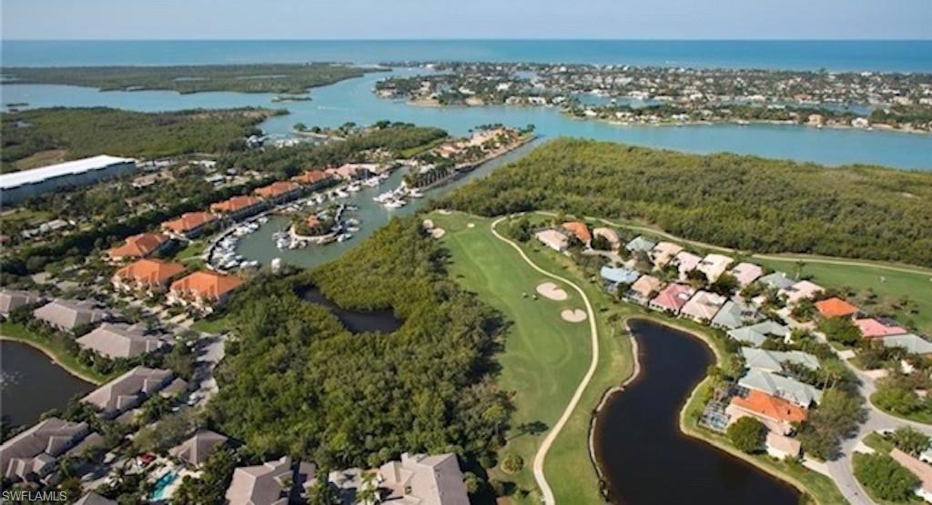 4650 Yacht Harbor Drive, Unit 132 Naples, FL 34112 - Photo 19 of 22 an aerial view of a house with a lake view