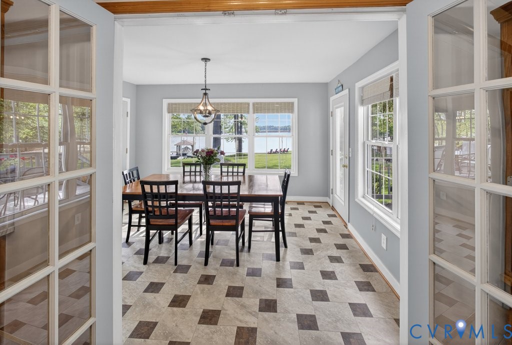 173 Covenant Way Bumpass, VA 23024 - Photo 14 of 55 a dining room with furniture a chandelier and rug