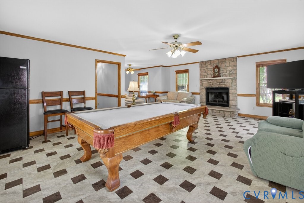 173 Covenant Way Bumpass, VA 23024 - Photo 16 of 55 a living room with a black white checkered floor with couches a fireplace and a flat screen tv