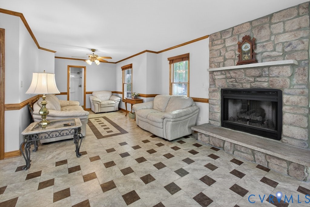 173 Covenant Way Bumpass, VA 23024 - Photo 20 of 55 Living area featuring a stone fireplace with a hea