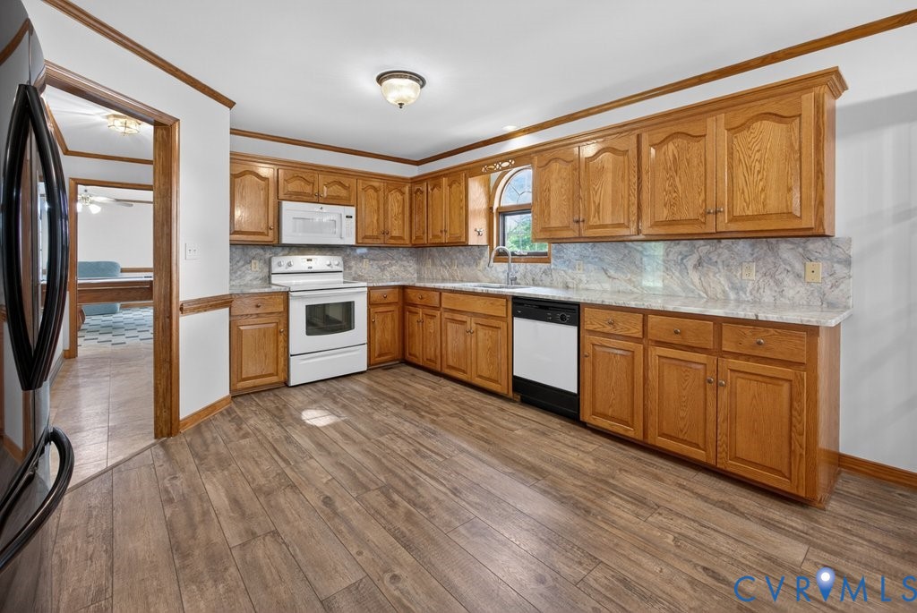 173 Covenant Way Bumpass, VA 23024 - Photo 10 of 55 a kitchen with stainless steel appliances granite countertop wooden cabinets a sink a stove a dining table and chairs