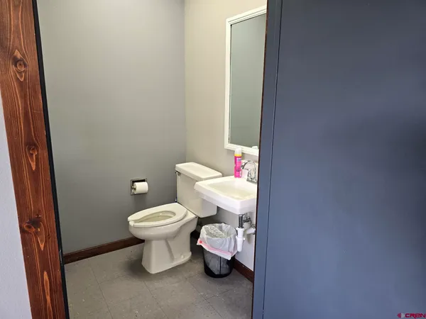 a white toilet sitting next to a bathroom sink