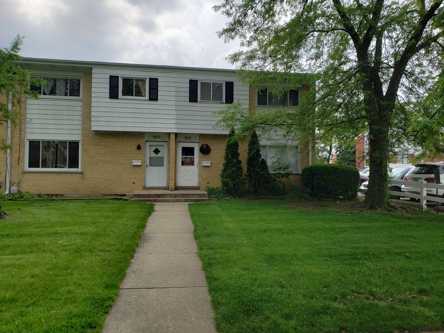a front view of a house with a garden