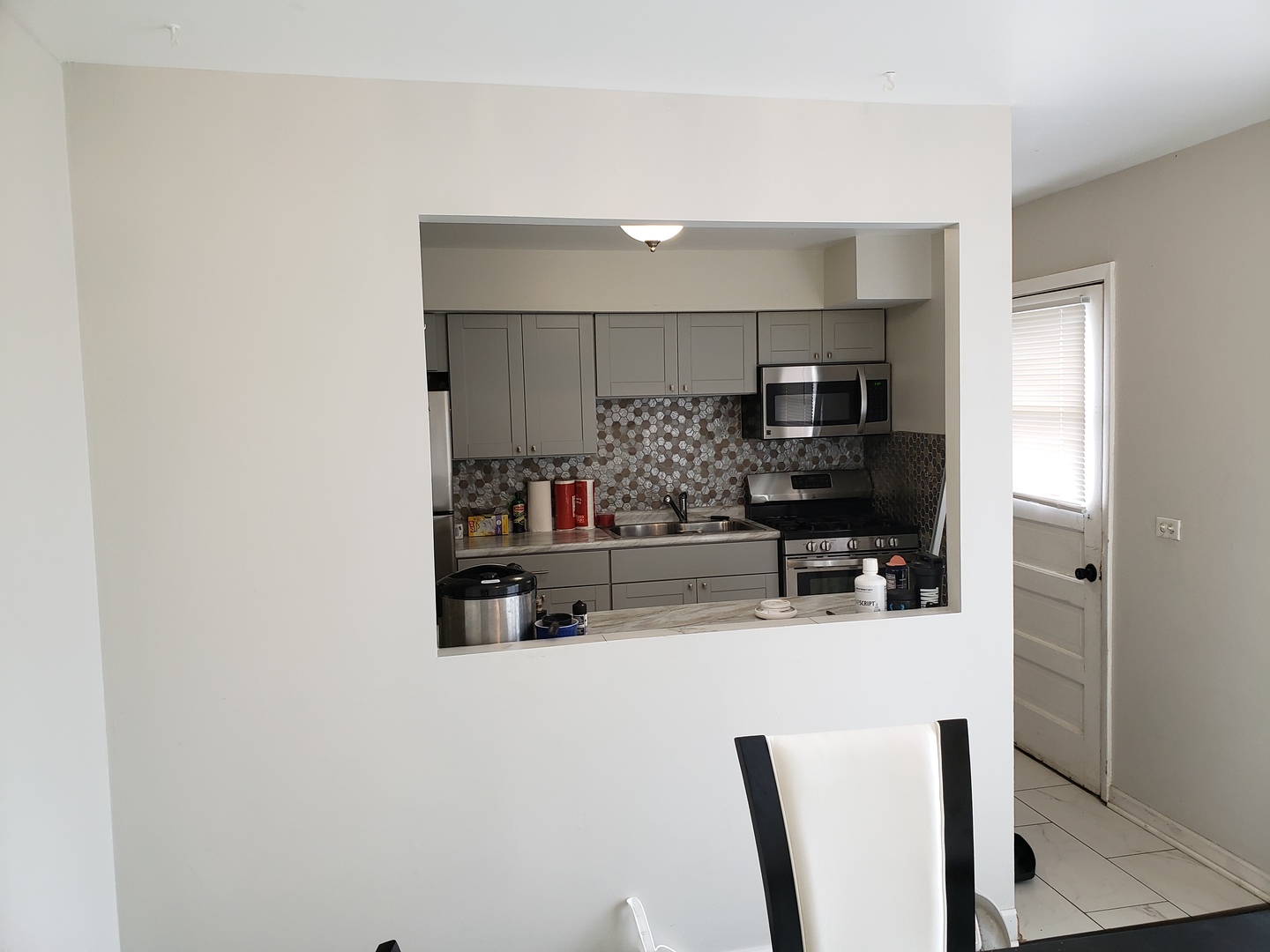 952 Virginia Lane Elmhurst, IL 60126 - Photo 3 of 11 a kitchen with kitchen island a stove and a refrigerator